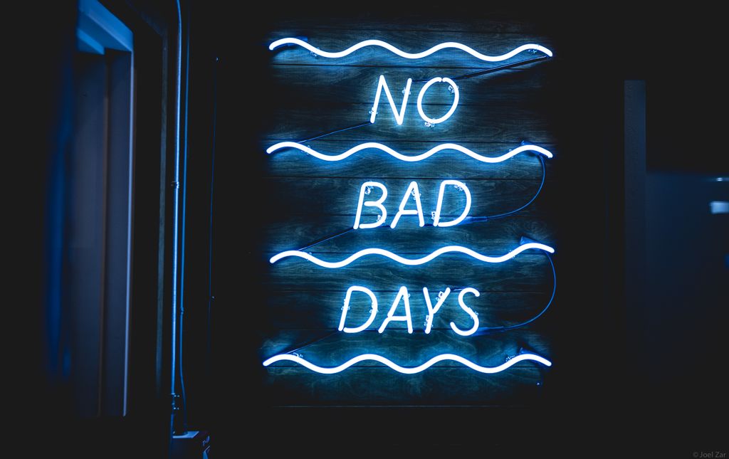 Bright neon sign reading 'No Bad Days' against a dark background.